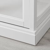 A sleek white wooden cabinet, showcasing fine craftsmanship with smooth edges and integrated dampers for silent closing.