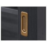 Golden handles on a sleek black wooden cabinet, showcasing high-quality craftsmanship and elegant design.
