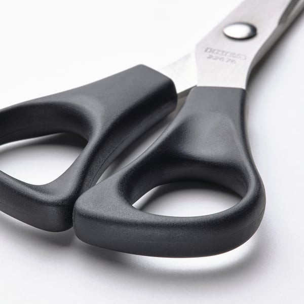 Close-up of high-quality stainless steel scissors with durable black plastic handles, designed for both right and left-handed users.