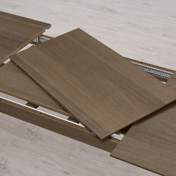 An extendable table section with one leaf pulled out, allowing for additional seating. Two leaves included for easy extension.