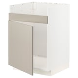 A white METOD kitchen cabinet with beige stensund fronts, featuring a single door and a wire shelf inside.