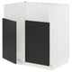 A white METOD kitchen cabinet with matt black doors. It a modern design with a frame and snap-on hinges.