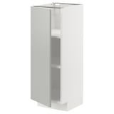 A white METOD kitchen cabinet with light grey door and shelf, featuring a modern minimal design.