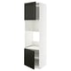 A white METOD kitchen cabinet with black bodbyn doors featuring beveled edges, including an open door revealing adjustable shelves inside.
