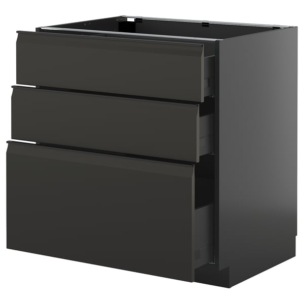 Modern black kitchen cabinet with three drawers, sleek design.