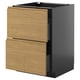 An ikea METOD kitchen cabinet with two wooden drawers in an oak finish and black sides. Its rectangular and modern in design.