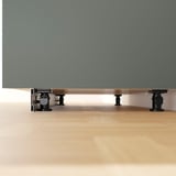 Metal kitchen cabinet legs with adjustable feet for stability on uneven floors.