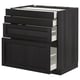 Black stained kitchen cabinet with four beveled edge drawers and a door.