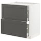Dark grey IKEA METOD kitchen cabinet with two open drawers in white frame.