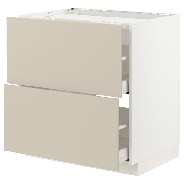 METOD kitchen cabinet in beige with smooth fronts, two bottom drawers partially open.