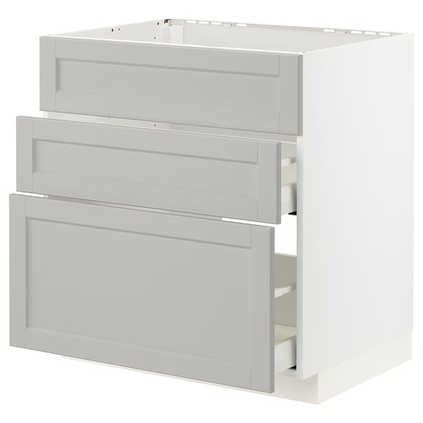 A white METOD kitchen cabinet with three light grey drawers.