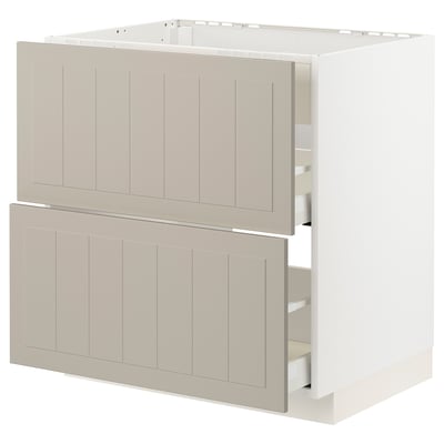 A beige METOD kitchen cabinet with two open drawers, featuring a panel design and a sturdy frame.