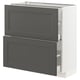 A white IKEA METOD kitchen unit with dark grey drawers and cabinet doors. It has a rectangular shape with a smooth finish.