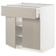 A beige METOD kitchen cabinet. It a smooth drawer, adjustable shelves, and sleek design.