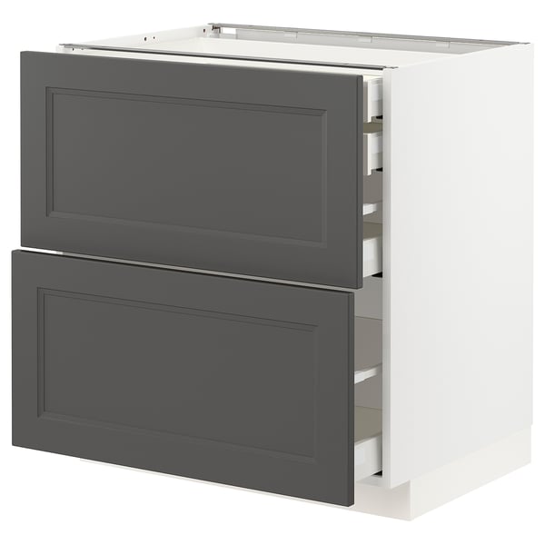 A white METOD kitchen cabinet with dark grey drawers. It has two large drawers with a classic design, set against a white frame. Sturdy and modern.