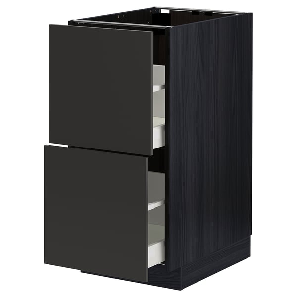 Modern black METOD kitchen cabinet with two open drawers, sleek design.