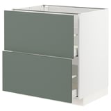 IKEA METOD kitchen unit with gray-green drawers and white frame.