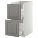 A white METOD kitchen cabinet with gray bodbyn drawers. The drawers have beveled edges and come with a 25-year guarantee.