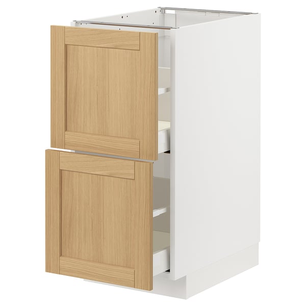 A white METOD kitchen cabinet with light oak veneer drawers and doors featuring a classic design with beveled edges.