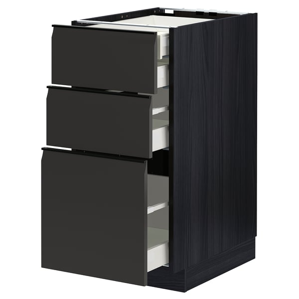 Modern black METOD kitchen cabinet with three open drawers, sleek design, sturdy particleboard and steel.