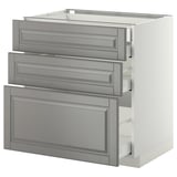 A grey METOD kitchen unit with partially open drawers and a cabinet.