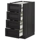 Black wooden kitchen cabinet with four partially opened drawers, sleek modern design.
