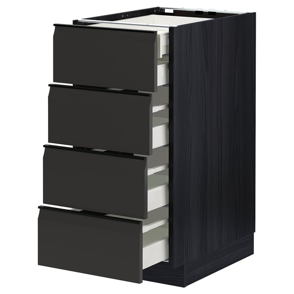Modern black kitchen unit with four partially open drawers, sleek edges, and integrated handles.