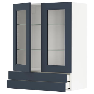 A blue METOD kitchen cabinet with glass doors and drawers. The glass doors have a modern look and the frame is made of particleboard and fiberglass.
