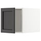 Black wooden kitchen cabinet with beveled edges, open showing interior shelving. Dark color, rectangular shape, classic design.