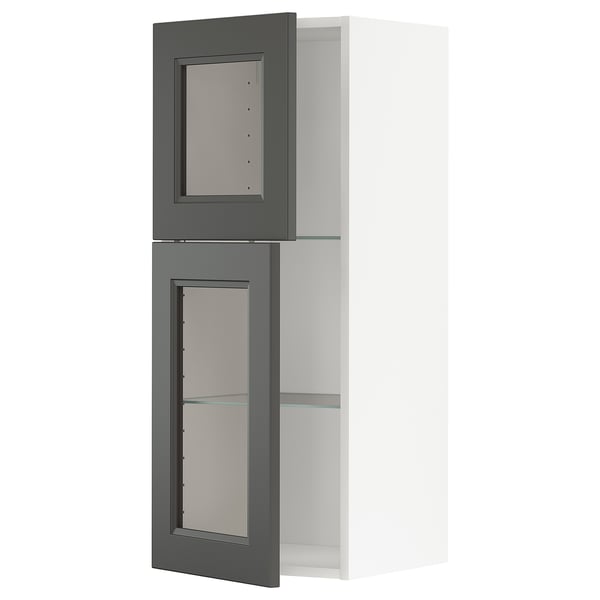 A grey METOD kitchen cabinet with glass doors and adjustable shelves.