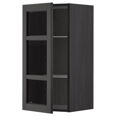 Black stained wooden kitchen cabinet with glass doors and shelves.