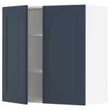 Blue kitchen cabinet with one door open, revealing an empty interior with one adjustable shelf. The cabinet is square-shaped with a modern design.