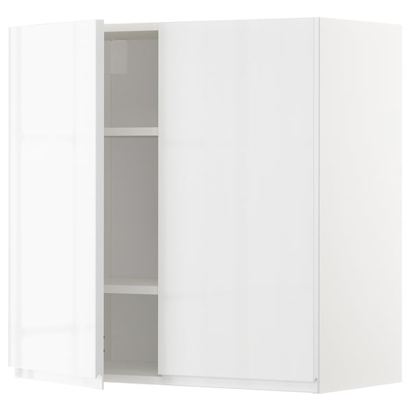 A white METOD kitchen wall cabinet with glass doors, modern and sleek design, featuring adjustable shelves and high gloss finish.