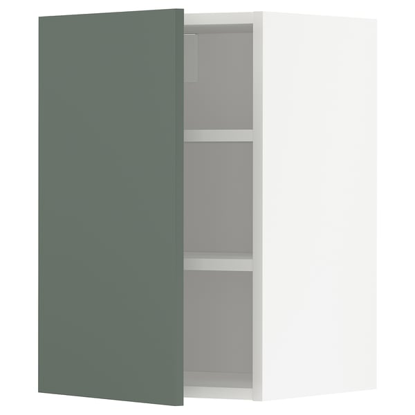 A greenish-grey METOD kitchen cabinet with two shelves and adjustable shelves. Its a modern, rectangular, wall-mounted design with a matte finish.