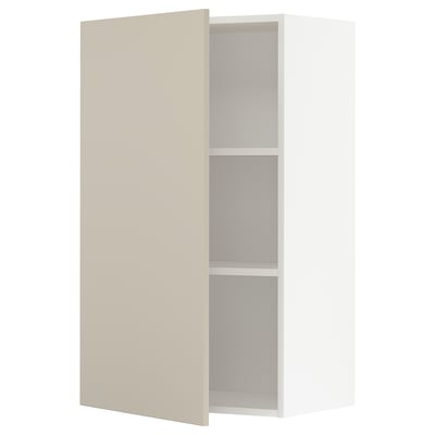 A beige METOD kitchen cabinet with a white interior and two shelves. The cabinet door is closed, and the design is sleek and modern.