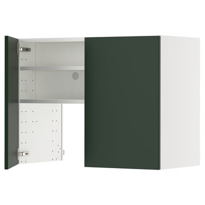 Green kitchen cabinet with open door showing shelves.