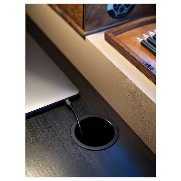 MICKE dark gray desk with laptop and cable outlet, wooden tray, pens.