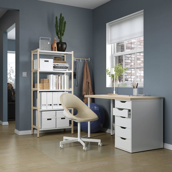 Home office setup with MITTCIRKEL desk, white chair, storage shelves, and window.