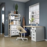 Home office setup with MITTCIRKEL desk, white chair, storage shelves, and window.