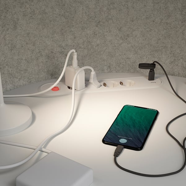 Work pod with integrated power strips, charging phone, and soundproof walls, enhancing focus and privacy.