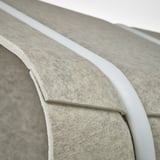 Modern office pod with sleek, curved design. High-quality fabric and sturdy metal frame ensure durability and comfort.