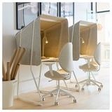 Three beige MITTZON soundproof work booths in office space with wheels, hooks, and built-in lights.