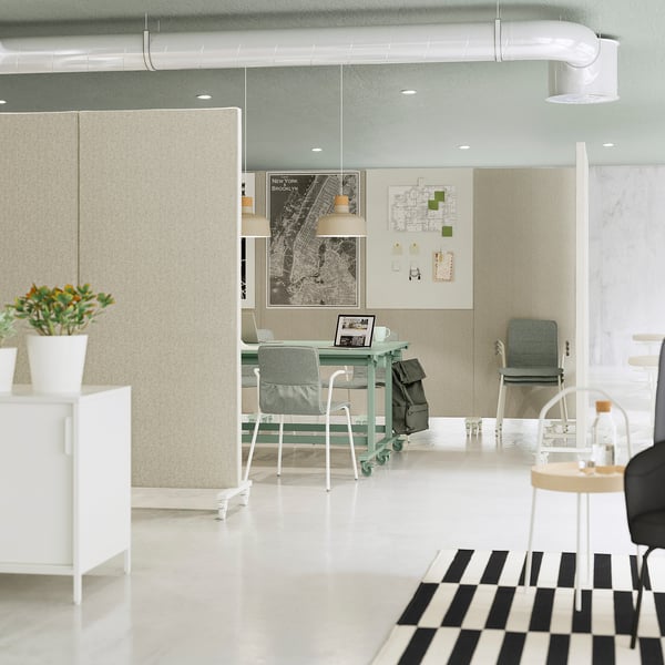 Modern office space with mitzon foldable tables in light green, maps on walls, plants, and sleek furniture.
