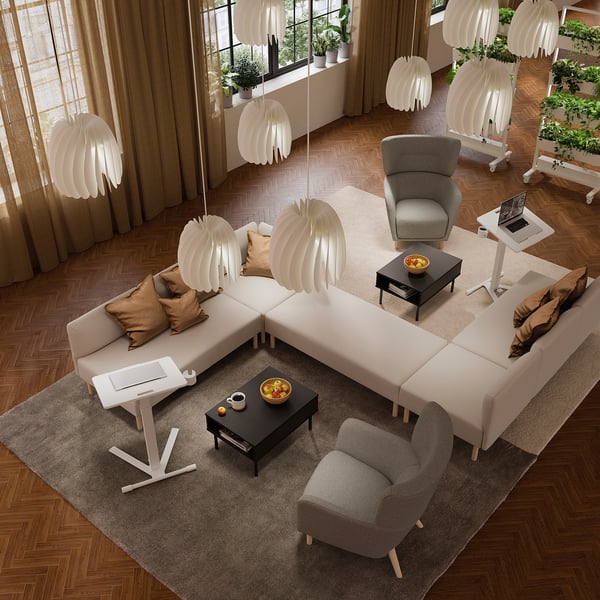 Modern office lounge with MITTZON adjustable tables, sofas, and lamps - ideal for work and relaxation.