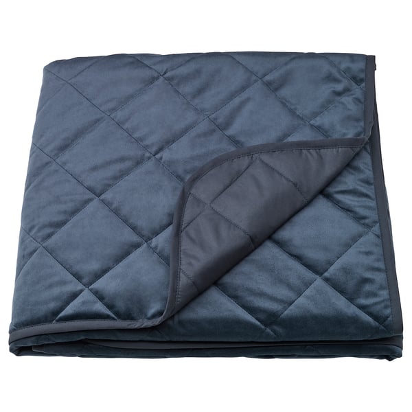 Dark blue MJUKPLISTER velvet bedspread, recycled polyester, folded, diamond quilted pattern.
