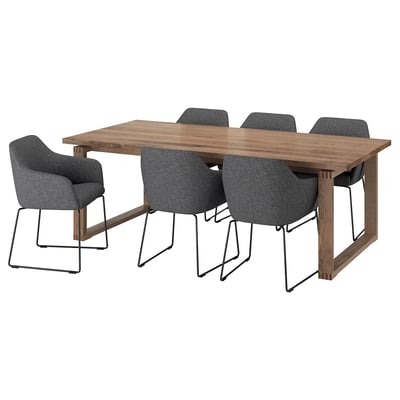 Modern dining set with wooden table and grey fabric chairs.