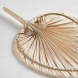 Handcrafted palm leaf wall decor. Natural, intricate weave. Artistic home accent.
