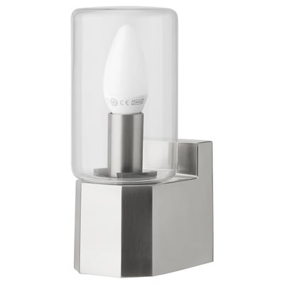 A MOLNSLAG wall lamp with a glass shade, nickel-plated aluminum body, and integrated power socket.