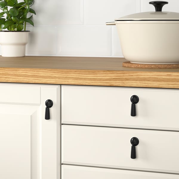 Kitchen: white cabinets, wood counters, plant. This version keeps the essential details while staying under the 150 character limit.