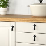 Kitchen: white cabinets, wood counters, plant. This version keeps the essential details while staying under the 150 character limit.